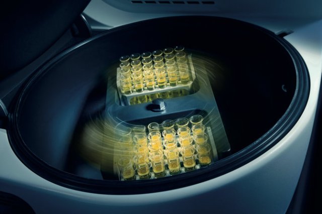 Inside of a benchtop solvent evaporator with several vials.