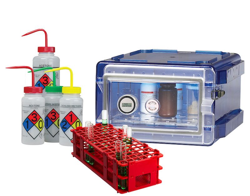 Labware and consumable items, including plastic squeeze bottle and a vial stand.