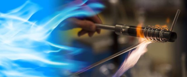 Custom glassware being heated with a blowtorch.