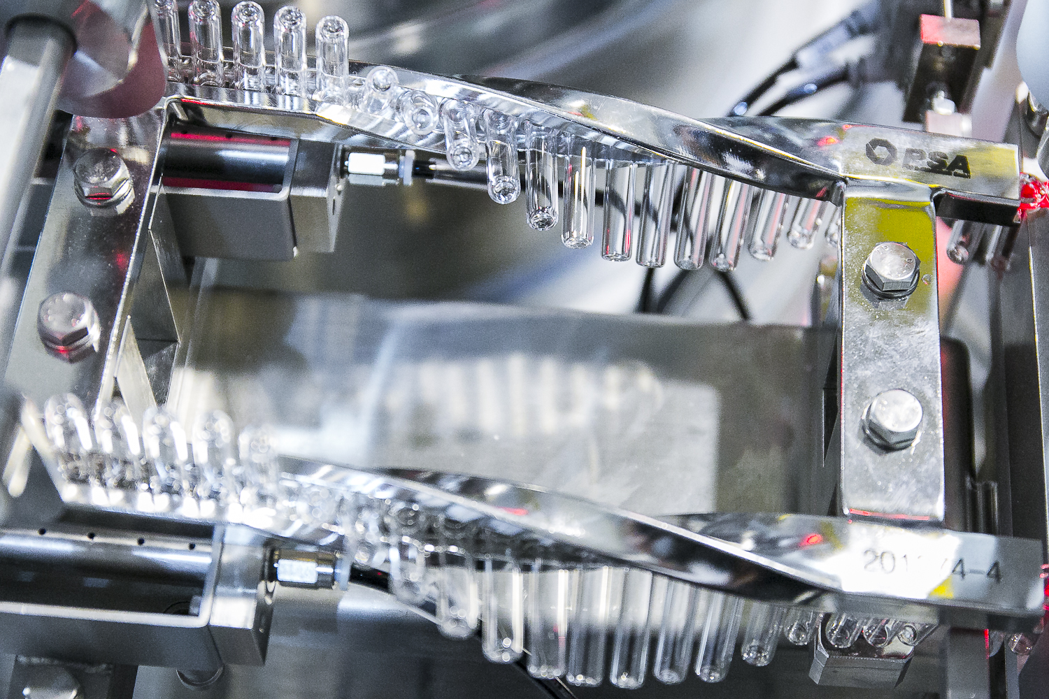 Machine manufacturing clear vials in bulk.