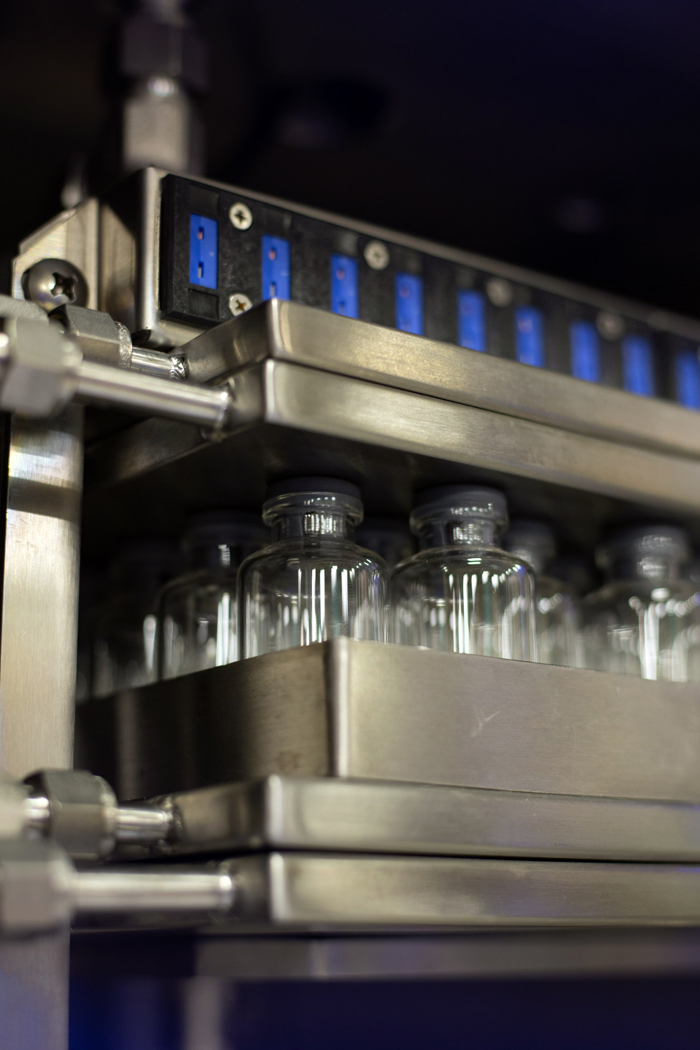 Up-close of a freeze dryer shelf with vials.